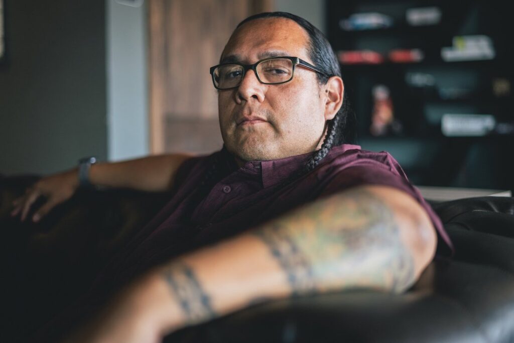 native american man sitting on a couch