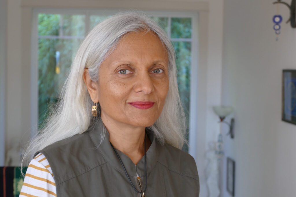 indian woman with white hair smiling