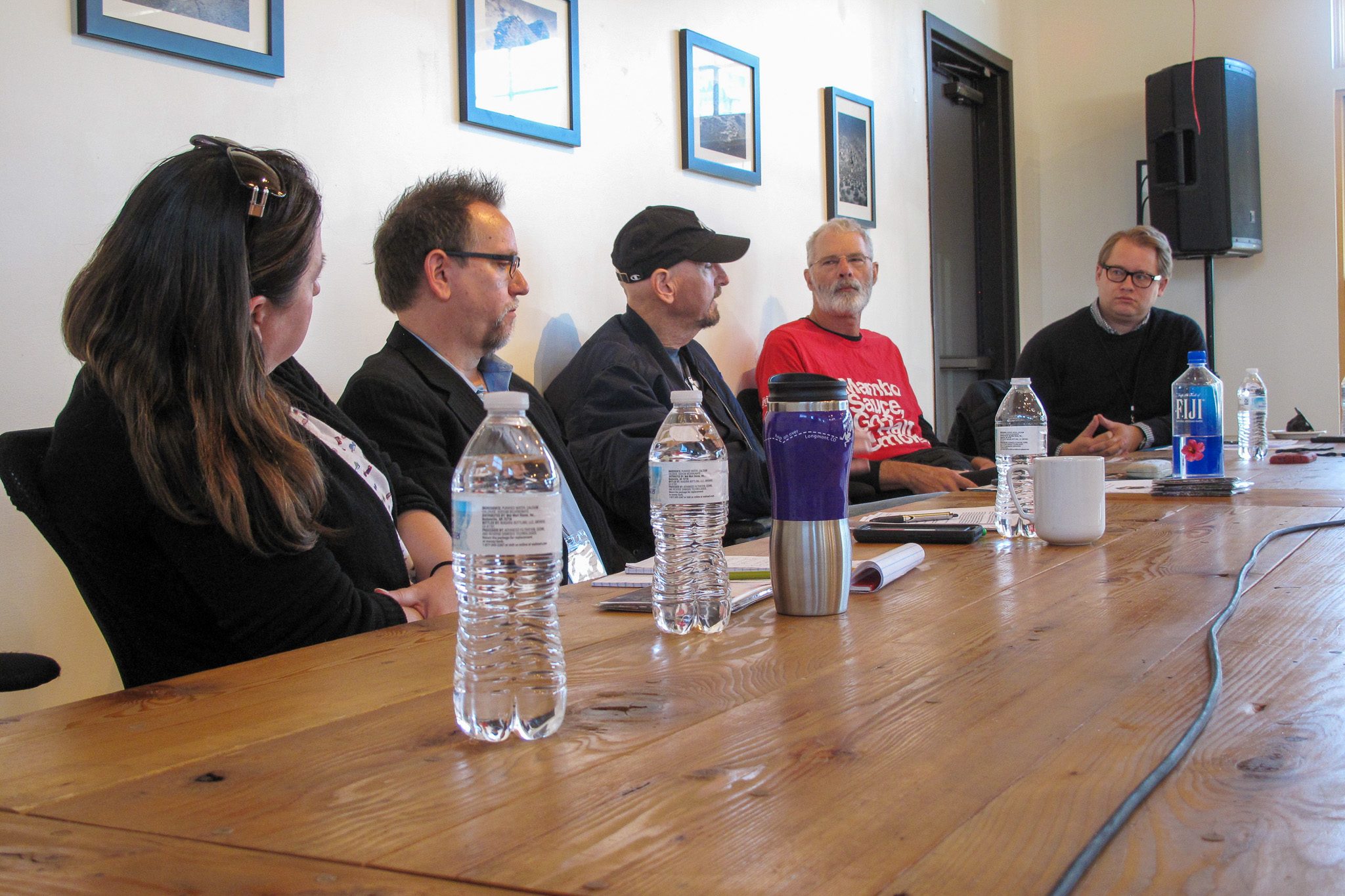 panel of authors seated at a table having a discussion