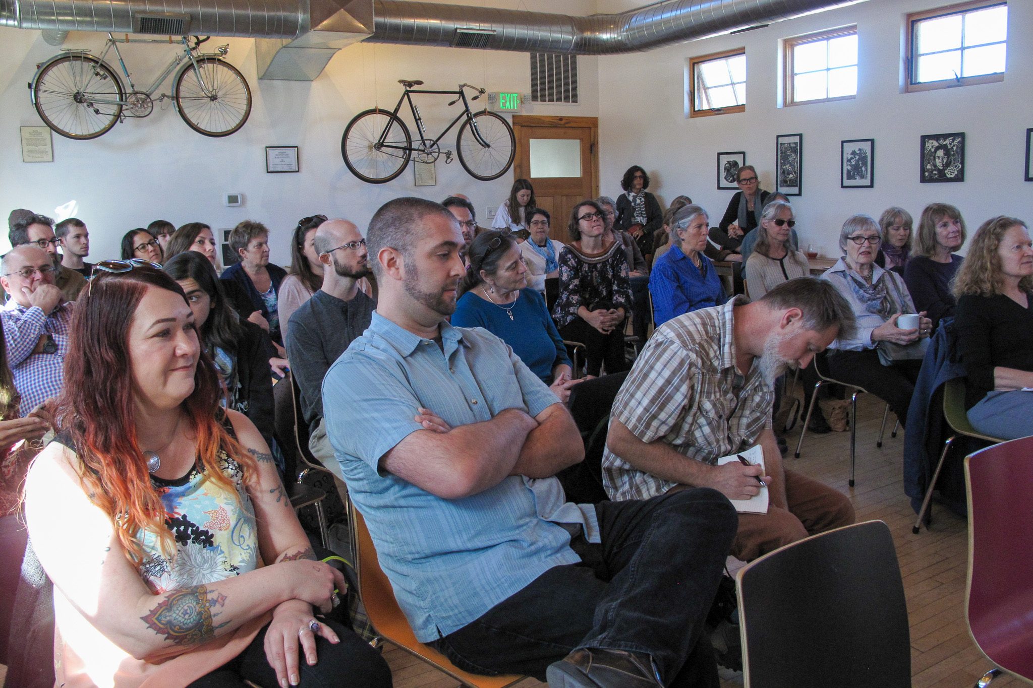 people seated in a room awaiting an author reading event