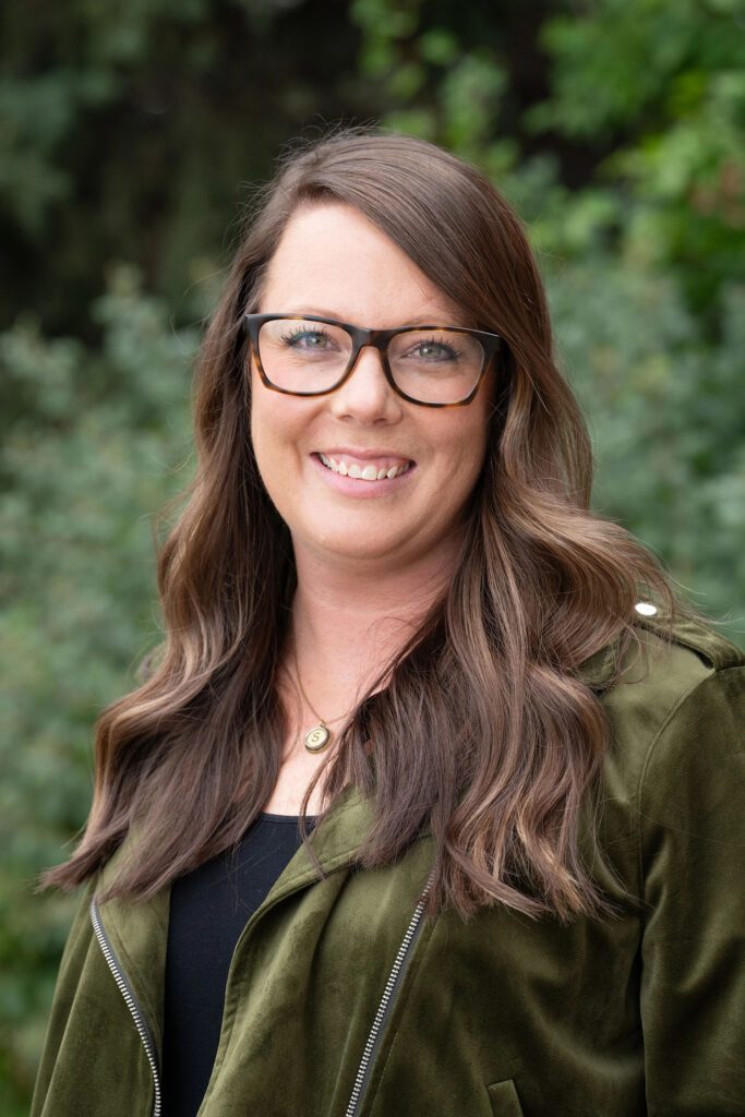 author kate shelton smiling for a photo outdoors