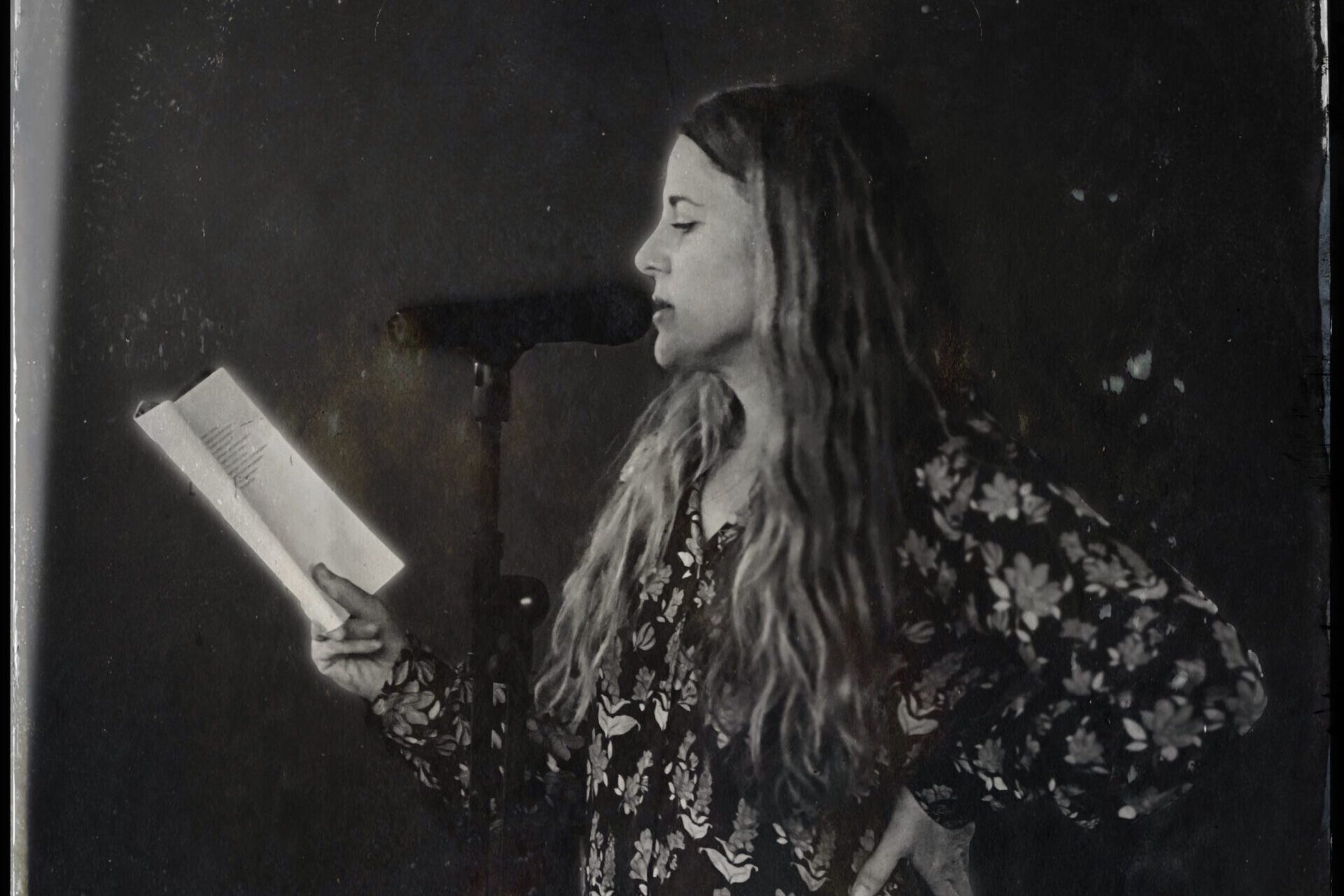 black and white image of poet sasha steensen reading a book