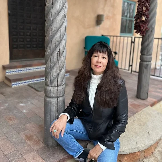 author deborah jackson taffa posed for a photo on a front porch