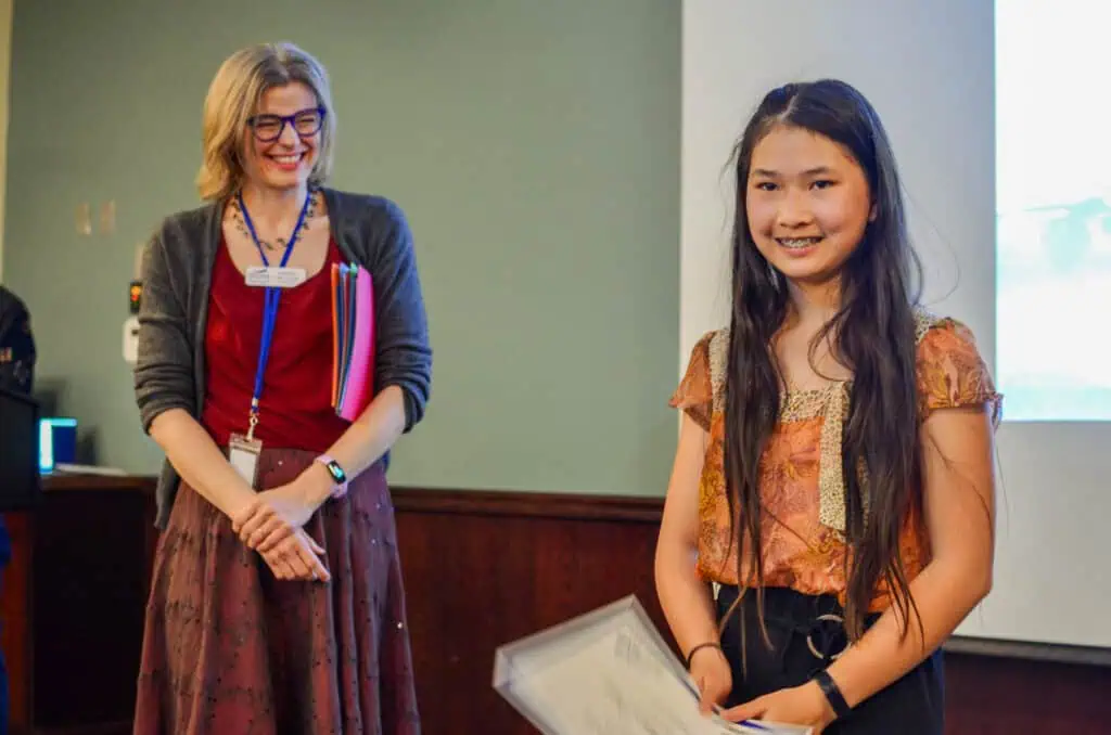 woman and young girl smiling at a poetry competition